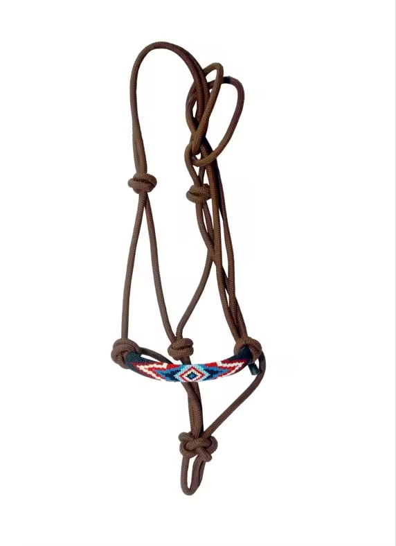 A brown leather horse halter with a decorative braided leather browband featuring red, blue, and white geometric patterns