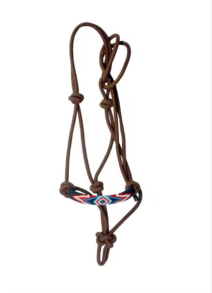 A brown leather horse halter with a decorative braided leather browband featuring red, blue, and white geometric patterns