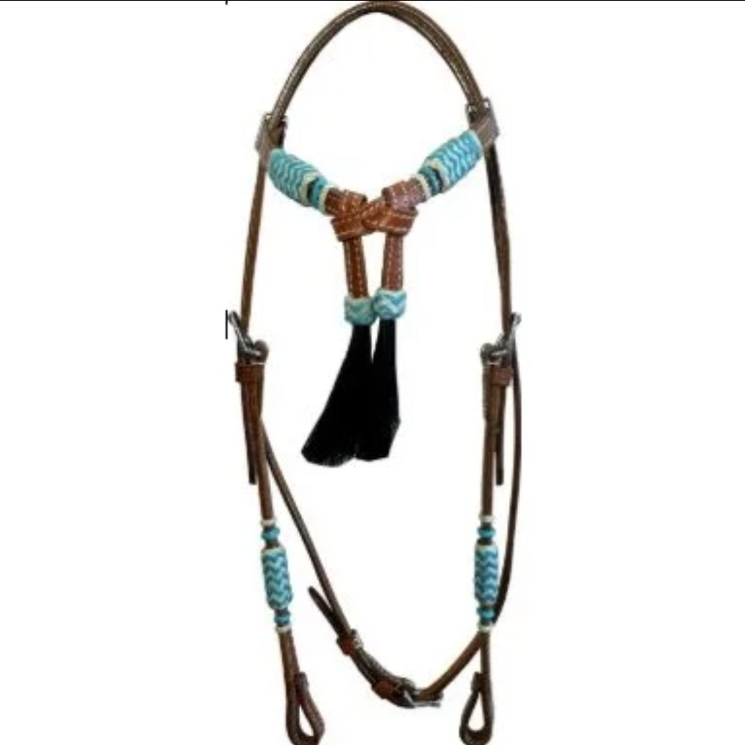 Brown leather horse halter with turquoise braided accents and a black hanging tassel